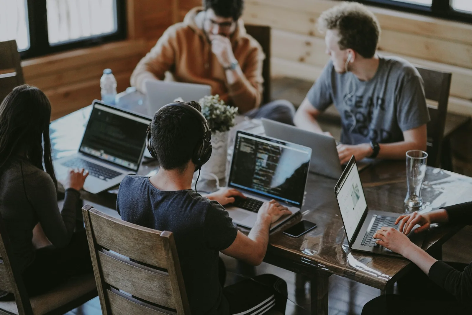 People working together around a table with laptops